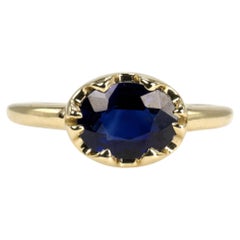 1.54 Carat Oval Blue Sapphire in East-West Belcher Inspired Gold Ring