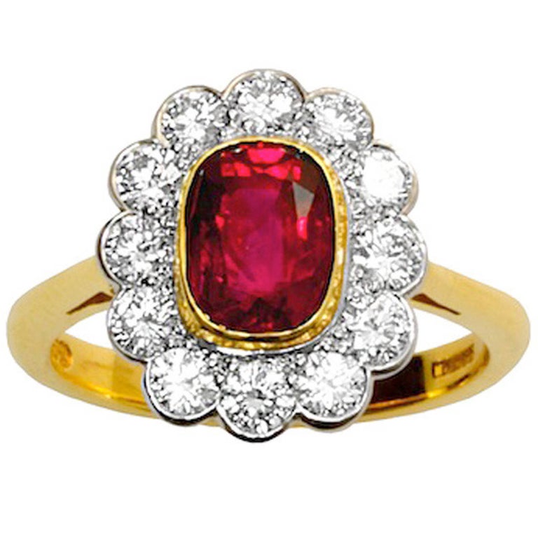 A stunning natural antique cushion-cut burmese ruby (no-heat, no oil) ring with brilliant-cut diamonds set in 18kt yellow gold and platinum. The 1.96 carat burmese ruby accompanies a gemological report from the American Gemological Lab stating the