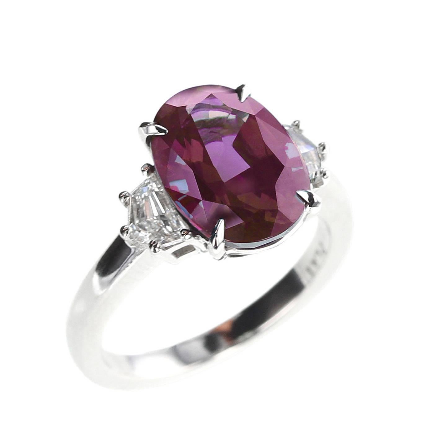 A classic three stone ring centered with a beautiful and natural, oval mixed-cut Alexandrite weighing over 5 carats accented with two shield-shape diamonds with a color clarity of F - VS and weighing 0.52 carats. The alexandrite accompanies a