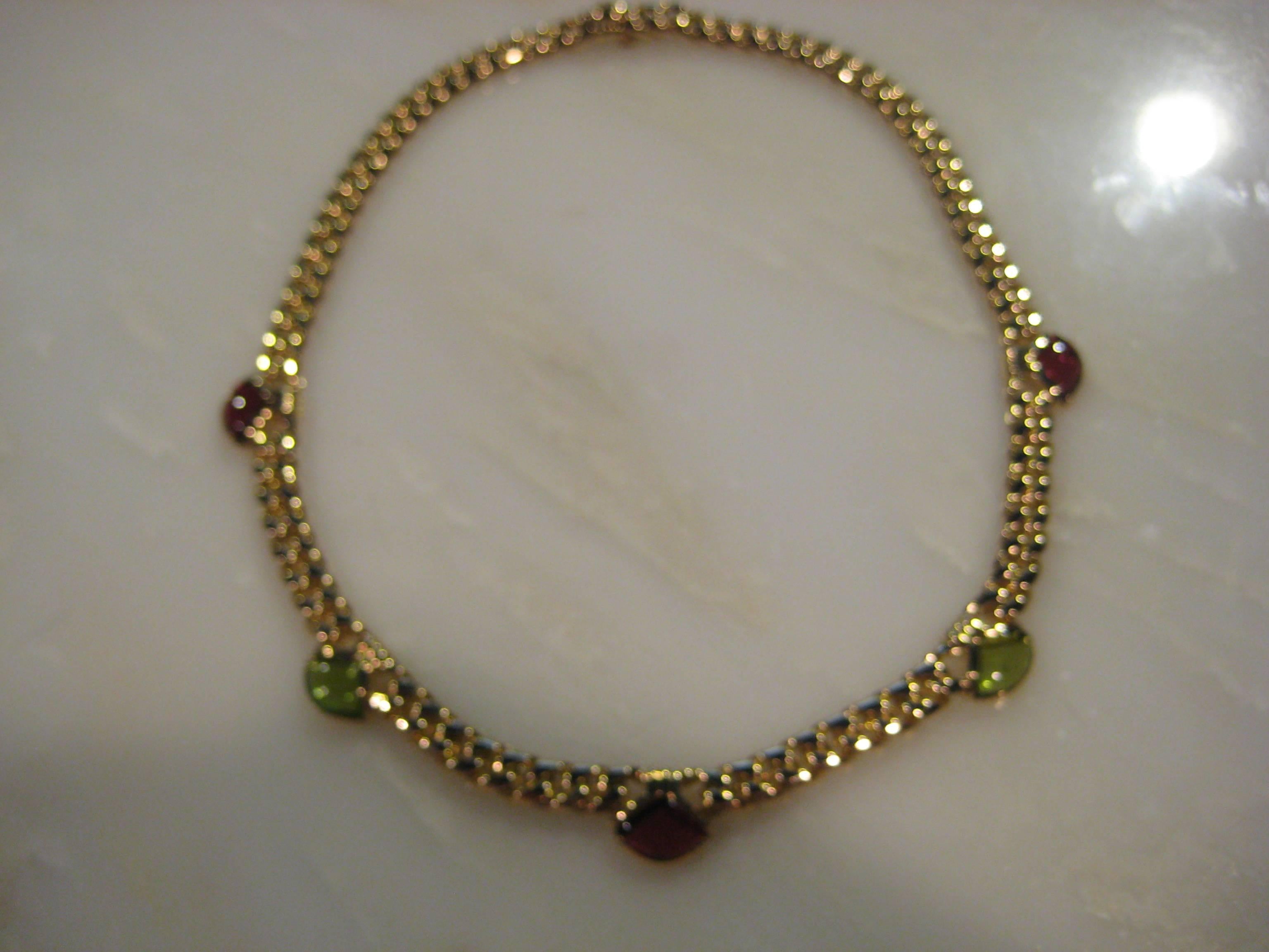 Bvlgari Bulgari 18KT yellow gold tourmaline link necklace. Necklace weighs 90.00 grams. Necklace is 16 inches in length and it is 1/2 of an inch at the width at the widest point were the tourmalines are set. 