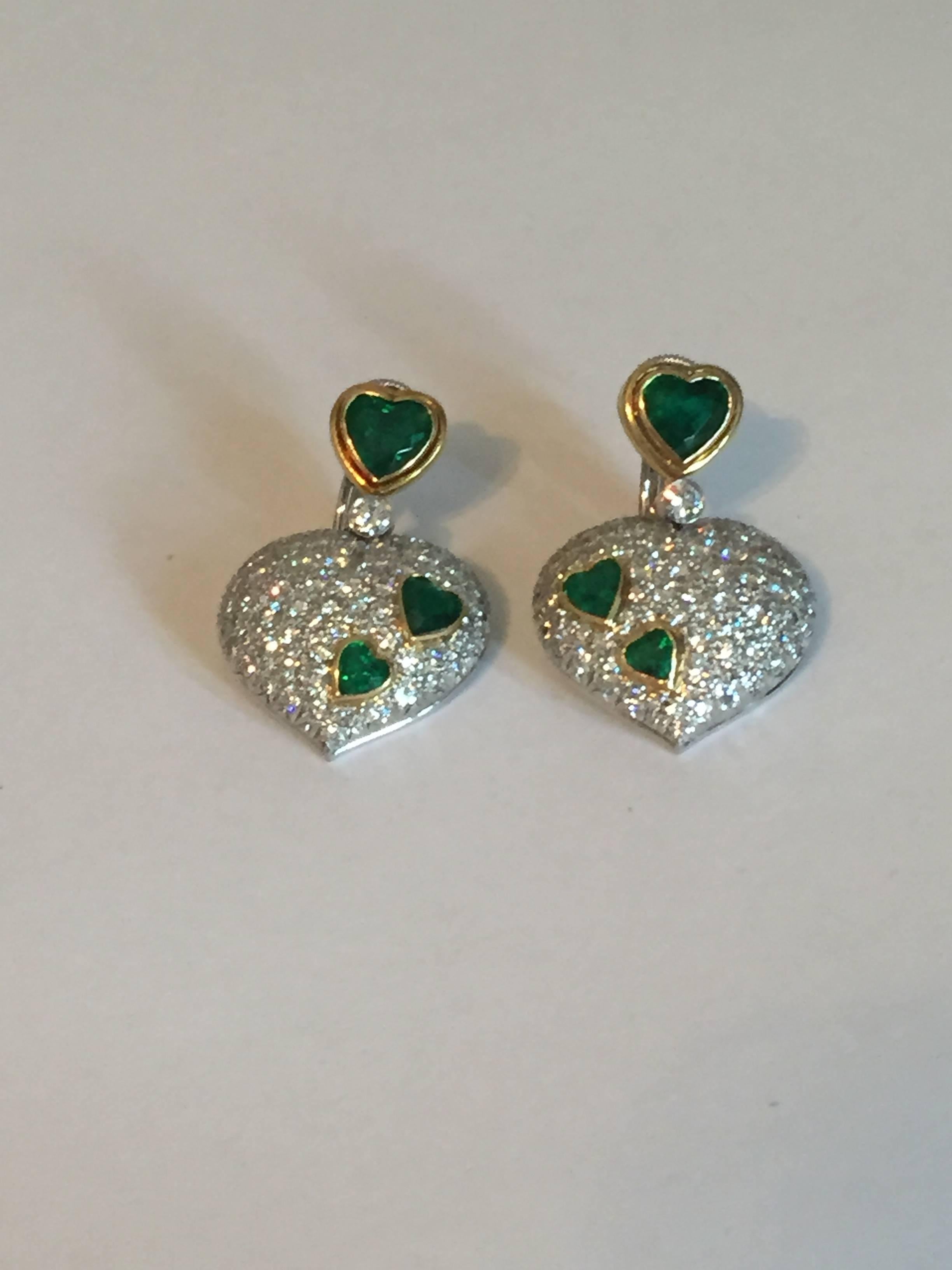 Vintage Harry Winston 18KT white and yellow gold diamond and emerald heart earrings. Earrings contain approximately 7.00CTS. in diamonds and approximately  5.00CTS. in emeralds. Diamonds are E - F in color and VVS - VS in clarity. Earrings weigh