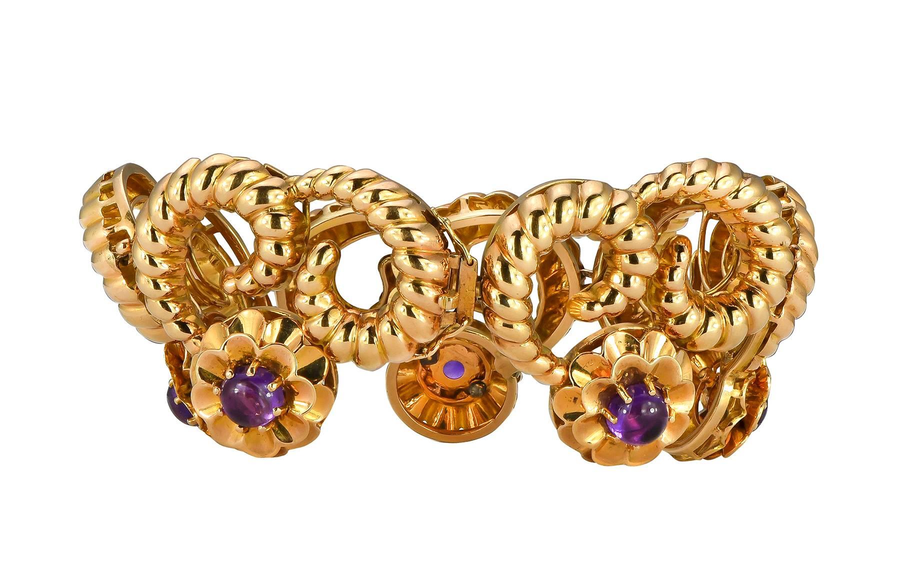 8.90cts cabochon amethyst 18k yellow gold scroll bracelet.  The amethyst are prong set in a floral design, suspended form the linked scrolls.

Length:  7.75 inches
Hallmark:  750