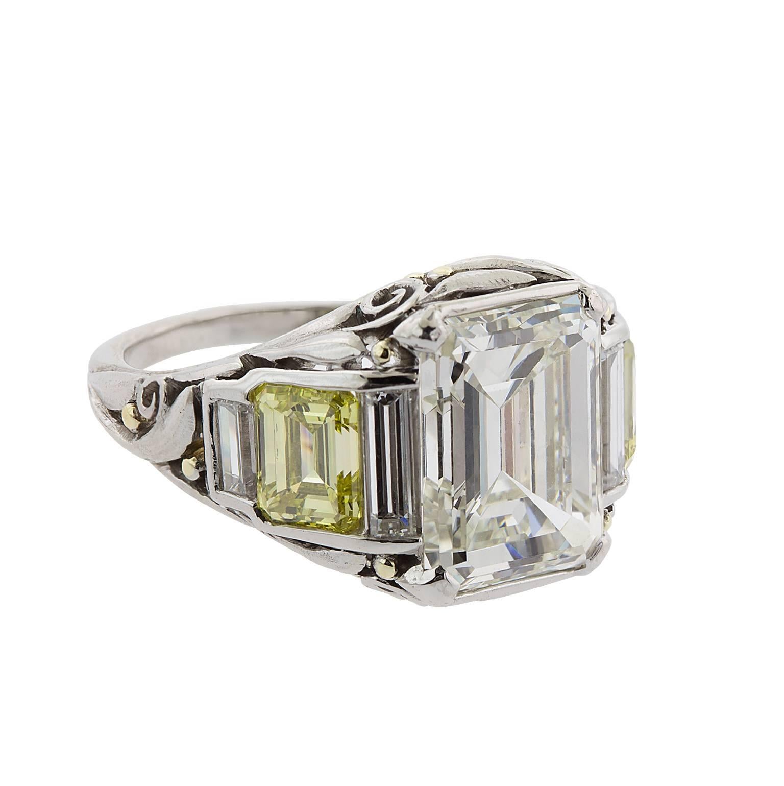 5.01 carat emerald cut diamond with two emerald cut fancy yellow diamonds, and four baguettes set in platinum and 18 karat yellow gold.  The center diamond is graded by GIA as L color, VS1 clarity.  Report 2185247956.  The two fancy yellow diamonds