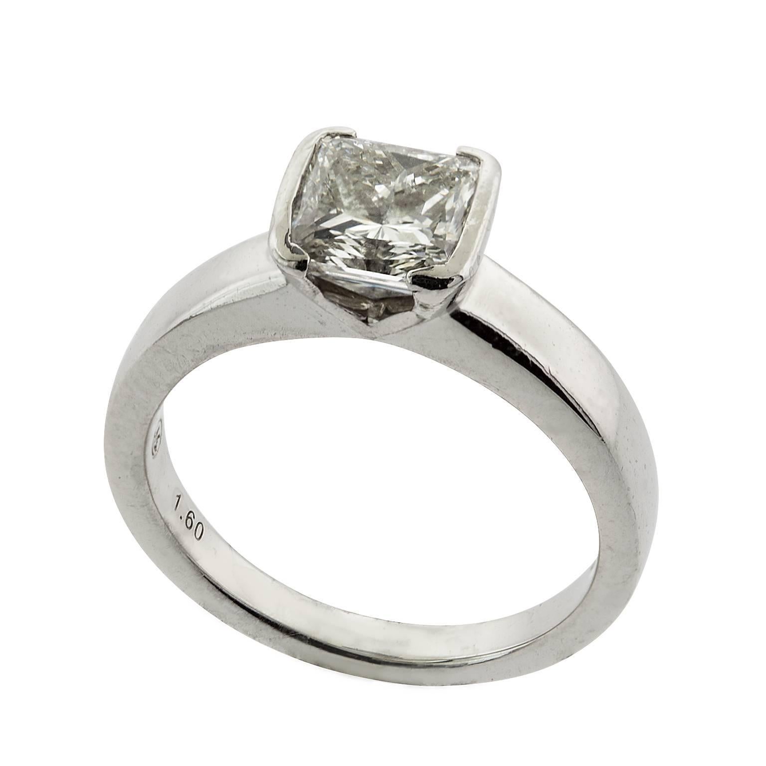 A 1.60 carat half bezel set princess cut diamond engagement ring in platinum.  The diamond is graded by GIA as H color, VS2 Clarity, and has an amazing amount of brilliance.  The half bezel head sits atop a tapered shoulder shank.  

GIA Report#: 