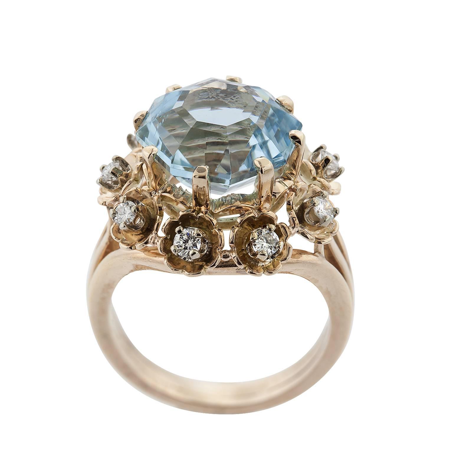 6.61 carat octagonal cut aquamarine and diamond 14 karat rose gold ring.  The aquamarine is set with eight prongs atop a single row of spaced round brilliant diamonds, set in floral designed gold.  The diamonds have a total weight of 0.54 carats,