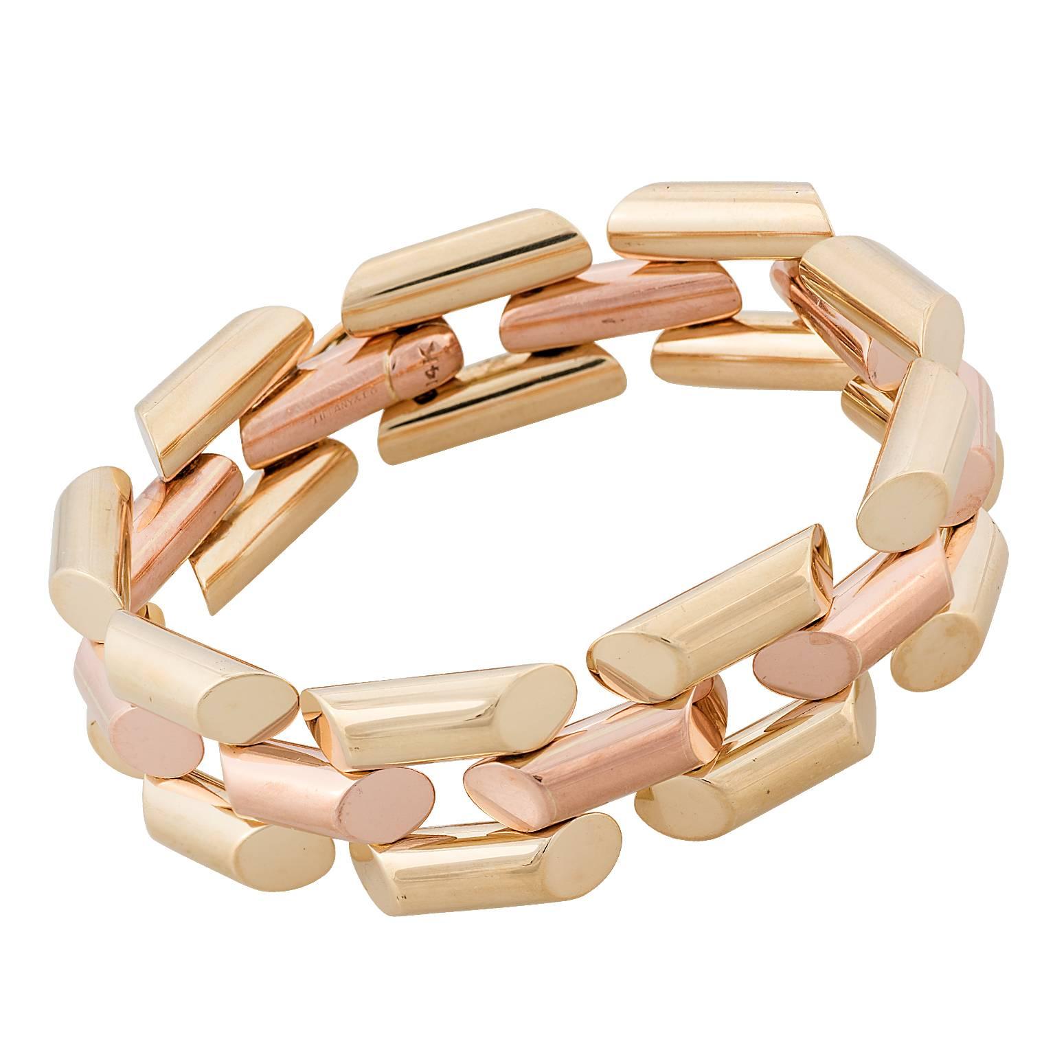 Tiffany & Co. 14 karat rose and yellow gold link bracelet.  The bracelet is designed with the center links being rose gold, with yellow gold outside links.
Signed Tiffany & Co.

Hallmark:  14K