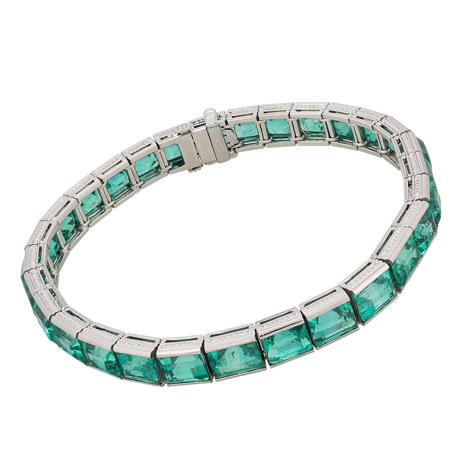 29.25 carats natural Colombian emerald bracelet in platinum.  There are 29 uniform color emerald cut emeralds, accompanied by a report from the American Gemological Laboratories (AGL) stating the origin of Colombia, as well as insignificant to minor