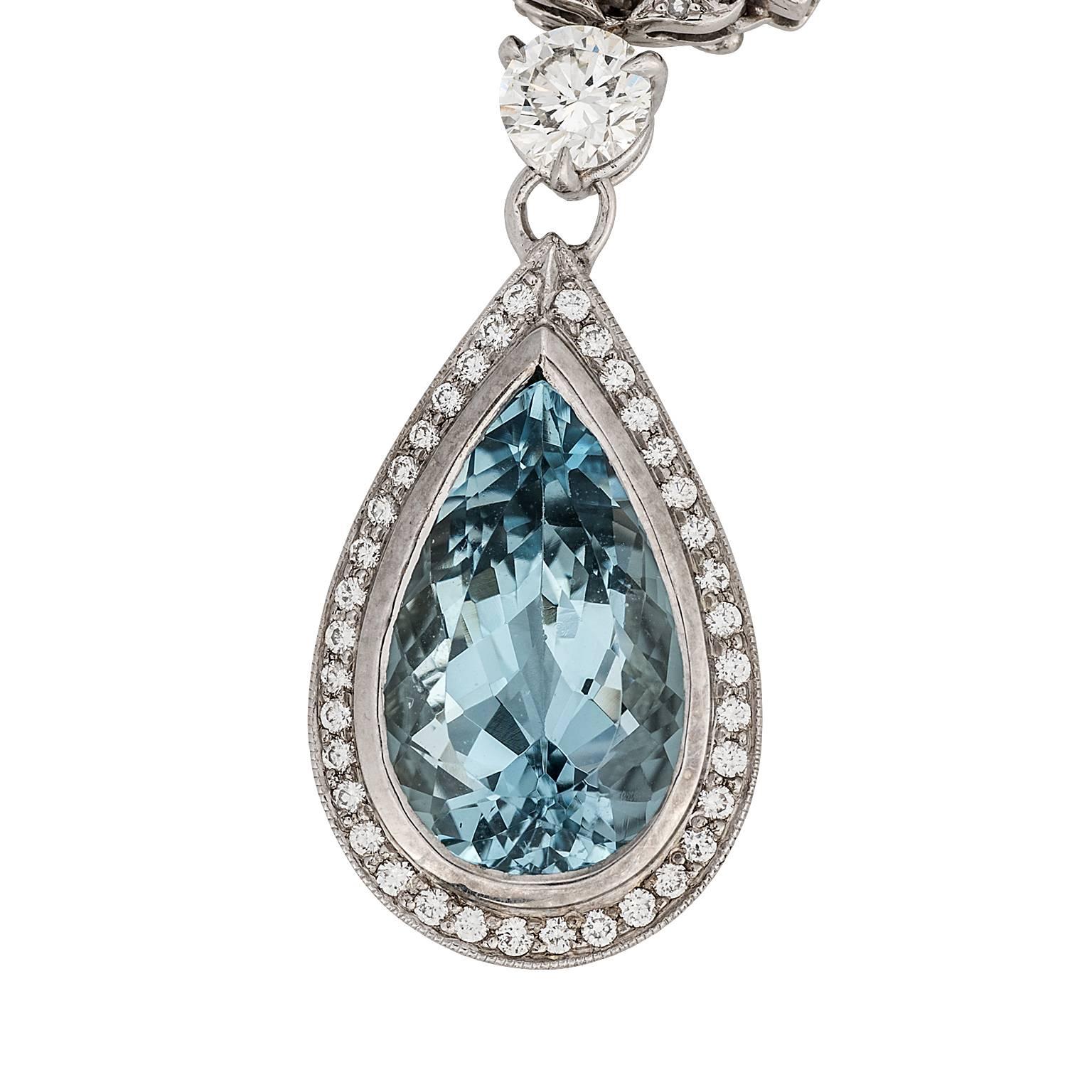 4.41 carat pear shape aquamarine and diamond 18 karat white gold pendant necklace.  The aquamarine is bezel set with a single row of round brilliant diamonds  surrounding, suspended from a 0.50 carat round brilliant diamond.  The pendant is