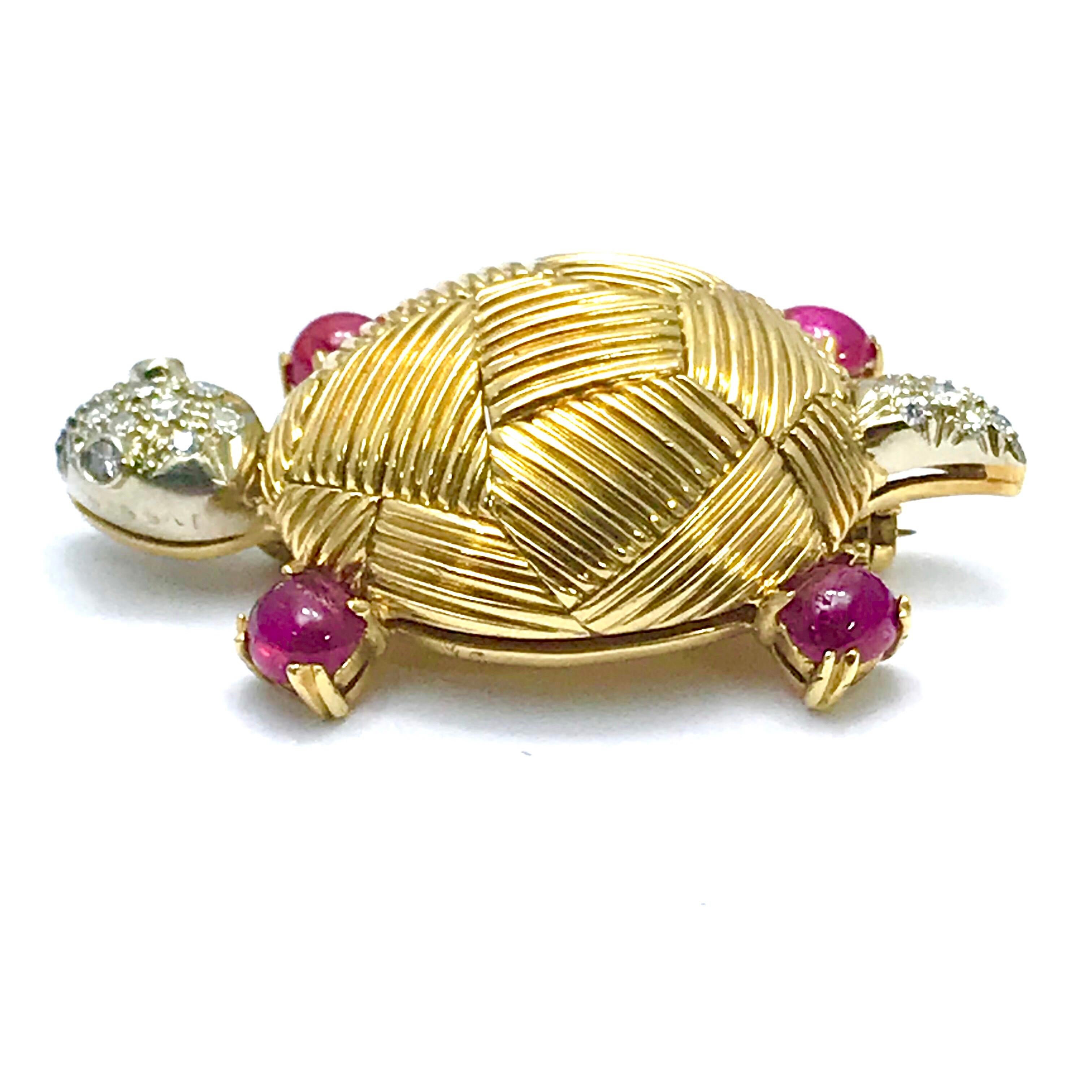 This is an iconic Van Cleef & Arpels cabochon ruby and Diamond 18 karat yellow gold turtle brooch.  Hand crafted with a textured shell, Ruby legs, and Diamond head and tail, it is a true work of art.  The four cabochon Rubies have a total weight of