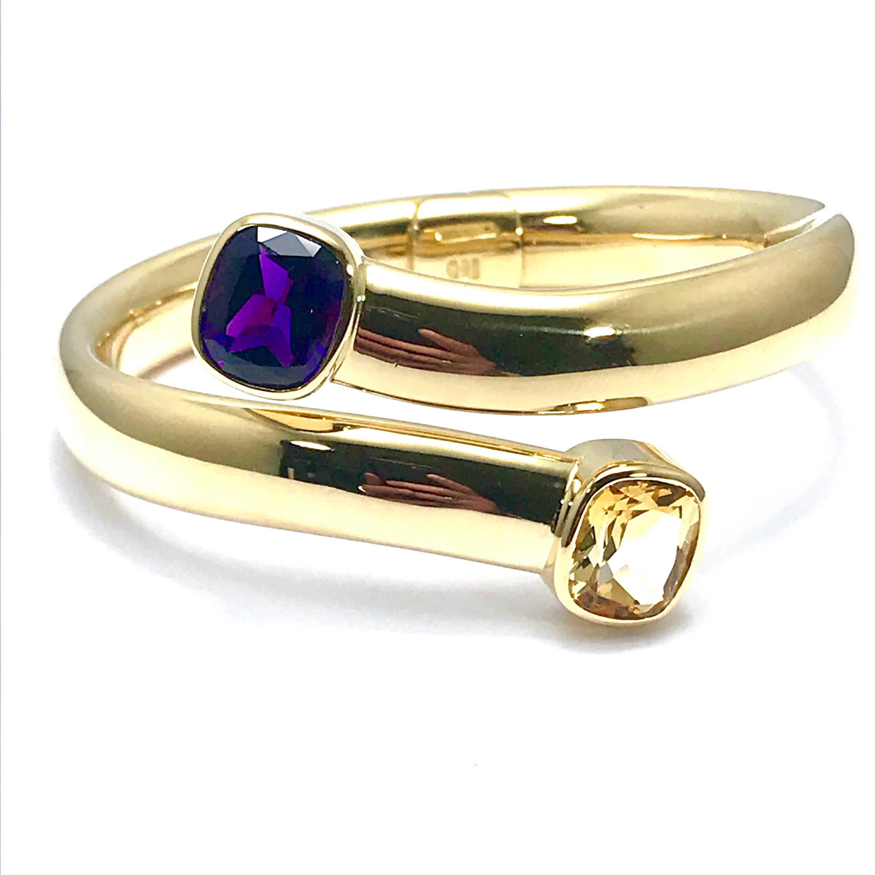 This is a great, easy to wear bracelet!  There is a 5.00 carat cushion shaped Amethyst, and a 5.00 carat cushion shaped Citrine in an 18 karat yellow gold hinged bypass bangle bracelet.  The stones are both bezel set at each end of the bracelet,