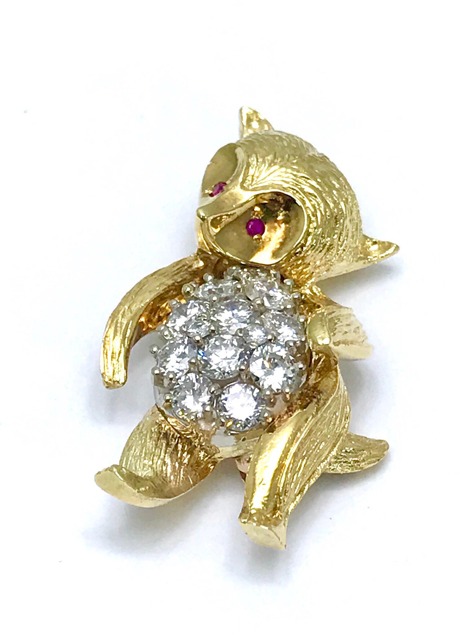 This is a beautifully detailed 1.50 carat round brilliant Diamond and Ruby eyes 18 karat yellow gold dancing bear brooch.  The bear is handcrafted in textured yellow gold, with an all Diamond stomach made of round brilliant cuts, and two Ruby eyes. 