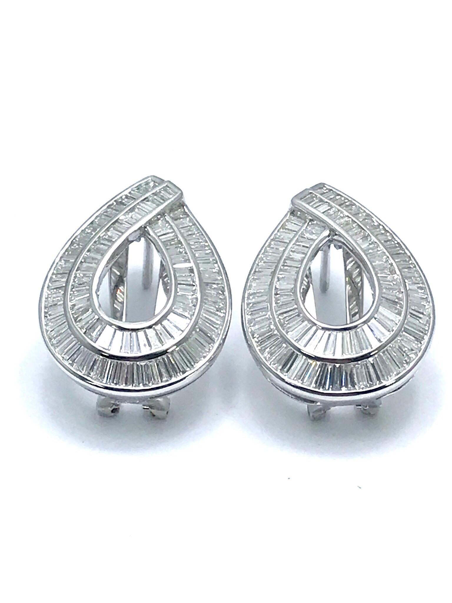 This is a stunning pair of 3.75 carats channel set baguette Diamond and 18 karat white gold clip and post earrings.  The baguette Diamonds are set in two rows making a pear shape, they are graded as G-H color, VS clarity.  The earrings feature a