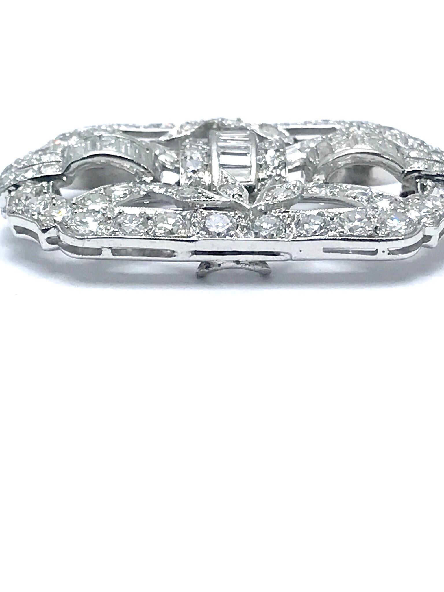 A beautiful Art Deco style Diamond platinum brooch and pendant.  The brooch is made up of round brilliant, single cut and baguette Diamonds.  There are 58 round Diamonds with a total weight of 3.14 carats, and 16 baguette Diamonds with a total