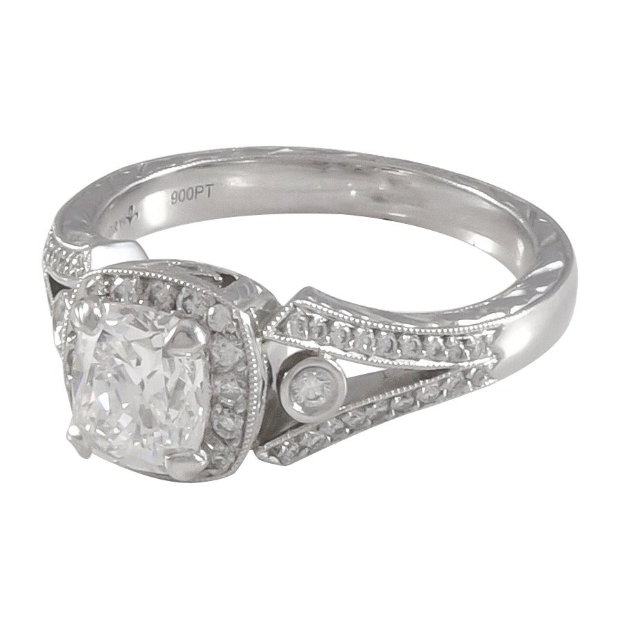 1.bague en diamant de 03 carats de forme coussin, avec un halo en diamant à une rangée et une demi-jarretière fendue en diamant en platine.  Le coussin est serti de quatre griffes, au sommet du halo, et d'un seul diamant serti en lunette de chaque