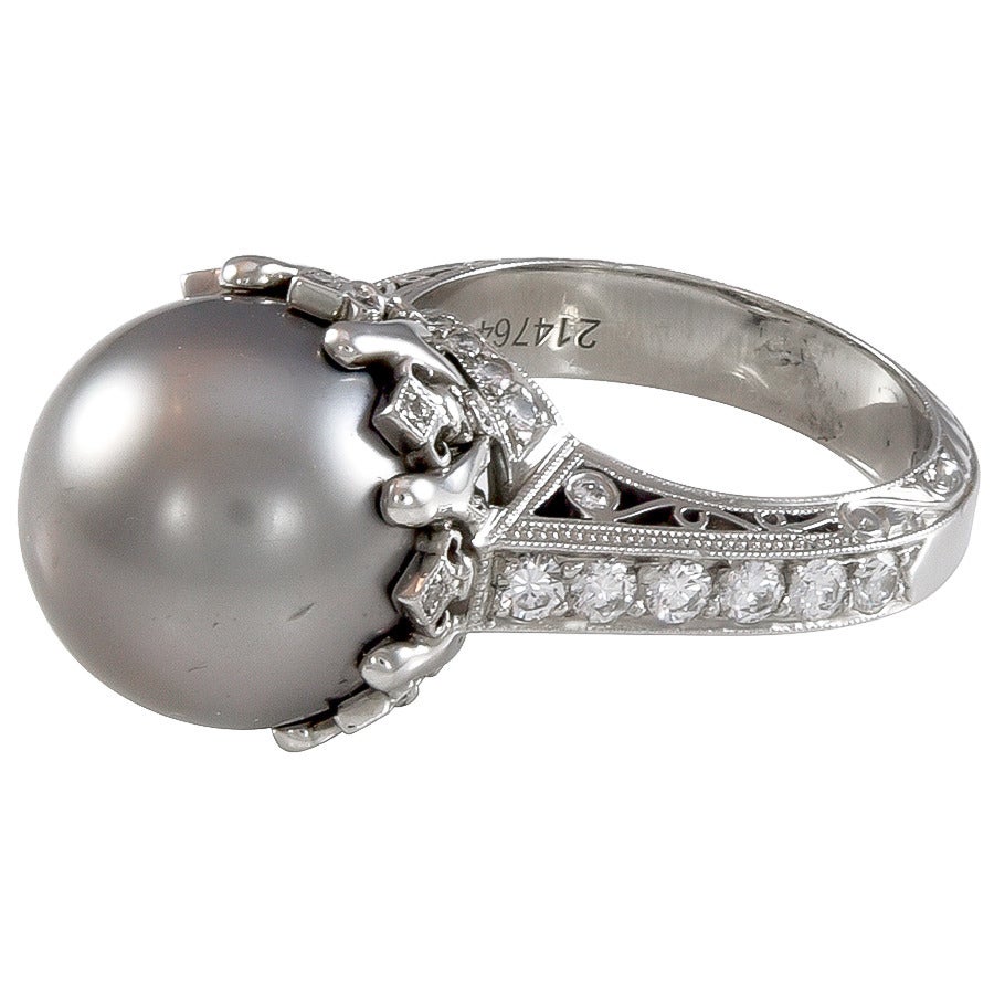 A wonderful 13mm Tahitian pearl and diamond ring set in platinum.  The pearl exhibits a beautiful deep grey color.  The diamonds are round brilliant cuts with a total weight of .62cts.

Signed:  Beaudry  PT950