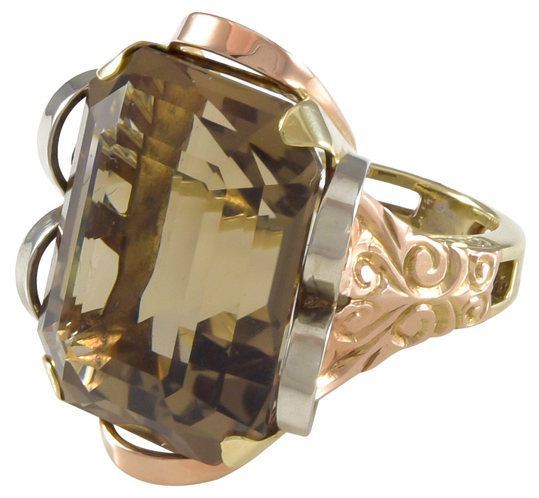 A wonderfully designed retro style smokey quartz ring in 14k yellow, white and rose gold.  The quartz by measurement has an approximate weight of 26.42cts.