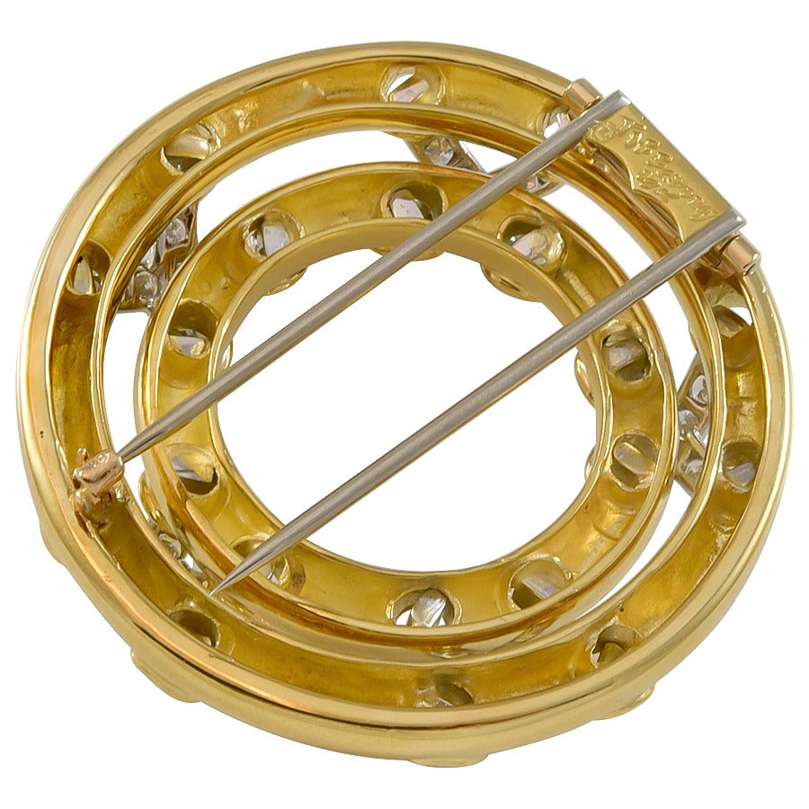 A large Tiffany & Co. Diamond  and 18k yellow gold circle brooch.  The diamonds are round brilliant cuts, and have an estimated total weight of 2.00cts
