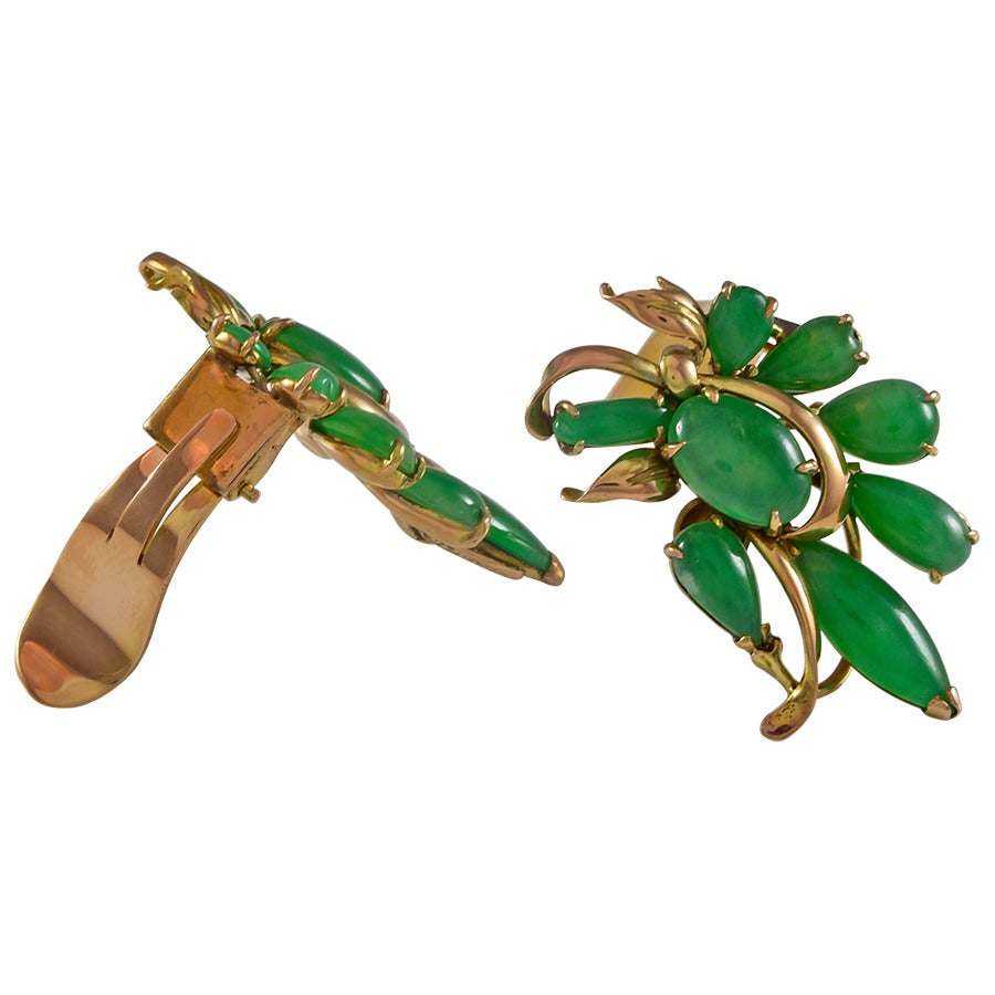 Beautiful rich green color jade earrings.  The jade is set in a 14k yellow gold floral design with clip backs.