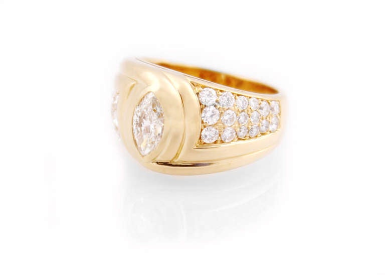 A wonderfully stylish wide band marquise and pave diamond ring designed by Bulgari.  The center marquise diamond is estimated to be 0.75ct G color, VS1 clarity.  The round brilliant pave set diamonds have a combined estimated weight of 0.75cts, all