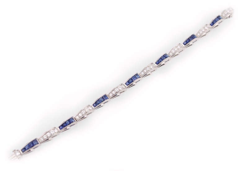 A vibrant sapphire and diamond bracelet designed by Oscar Heyman.  The beautiful blue sapphires are 8.15cts total, with 3.14cts total in diamonds, all set in platinum..  The diamonds are E-F color, VS clarity.  Stamped with 