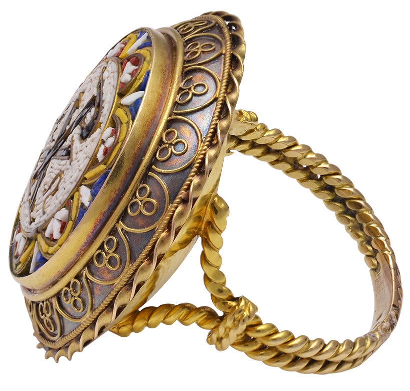 A beautifully made micro mosaic ring in 18k yellow gold.  The characters symbolize Alpha, the first letter of the Greek alphabet, and Omega, the last letter of the Greek alphabet, became a symbol for Christ due to His being called “the First and the