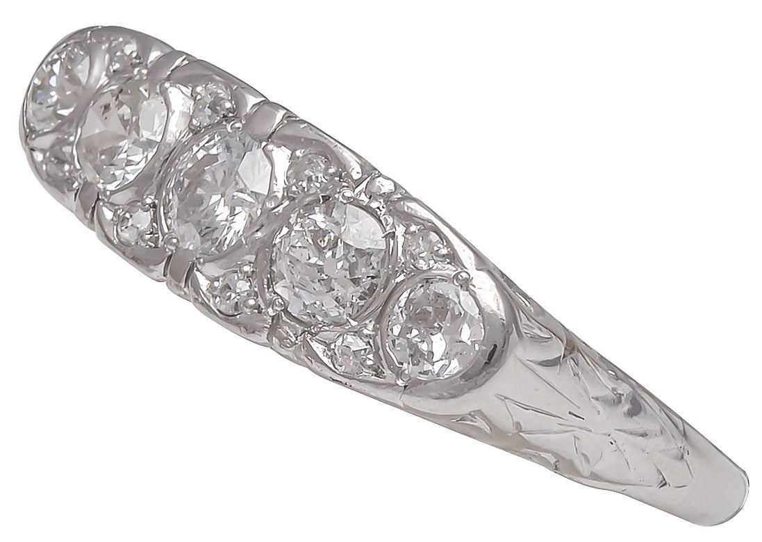 Art Deco old European cut diamond band.  There are 13 diamonds with a total estimated weight of 1.20cts, set in a hand engraved platinum mounting.