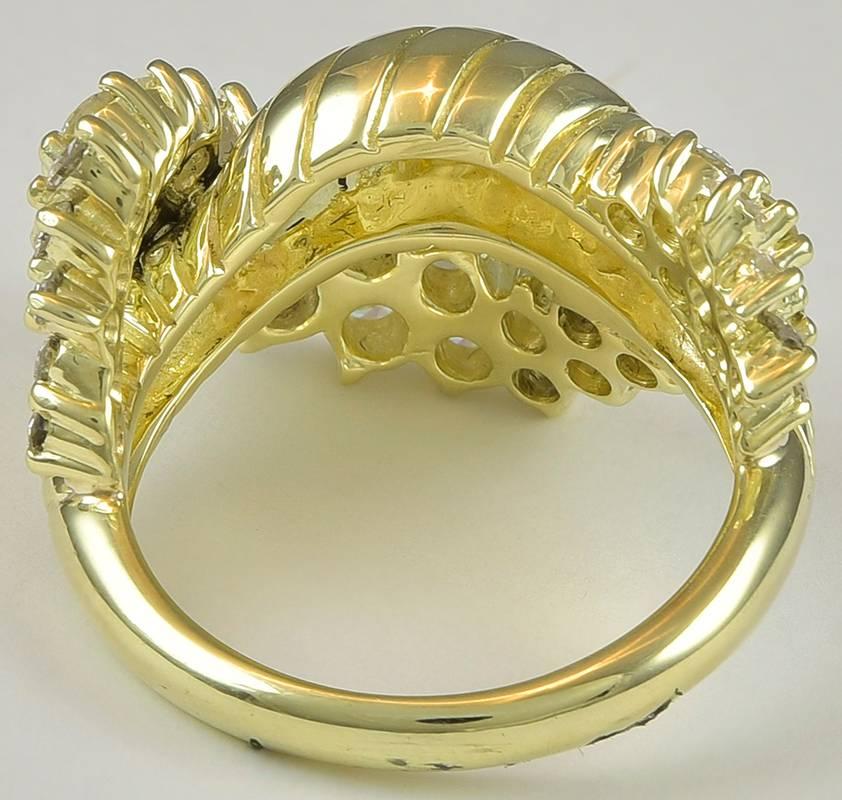 A gorgeous round brilliant diamond twist fashion ring in 18K yellow gold.  The ring contains 35 prong set diamonds with a total weight of 2.00cts.  The diamonds are F-G color, VS clarity.

Serial # 147568
(no signature)

*Currently a finger