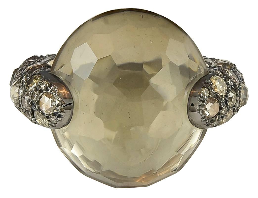 From the Pomellato Tango collection, this ring features a 23.61ct faceted dome cut smokey quartz center stone, set with an estimated 2.50cts in rose cut and round brilliant brown diamonds in 18k rose gold with black rhodium finish.

Signed: 