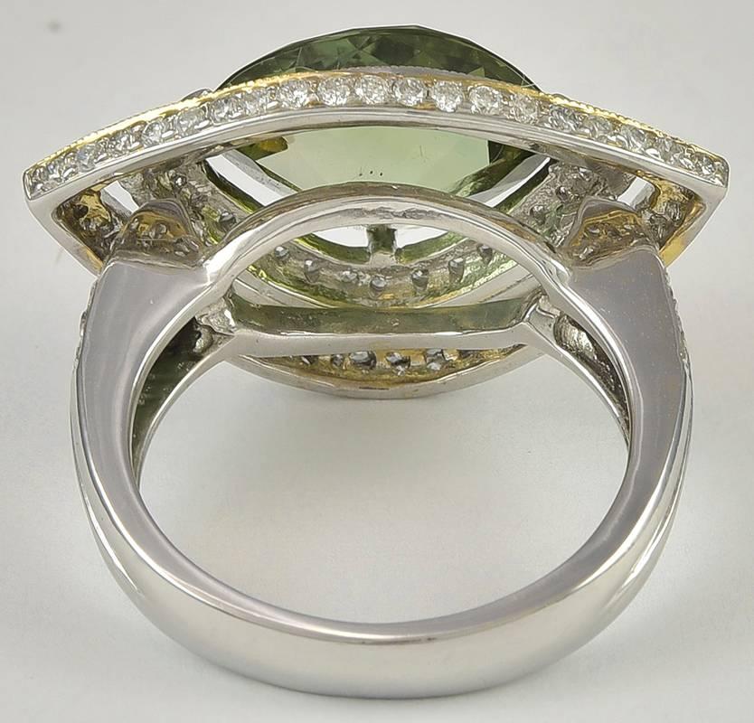 This is a great peridot fashion ring!  The 4.64ct peridot is prong set, with two subset rows of diamonds in 18K white and yellow gold.  The diamonds are round brilliant cuts, weighing 1.95cts total.

Hallmark:  18KT  750

*Currently a finger