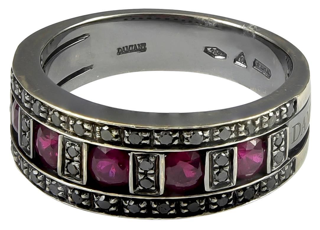 A gorgeous Damiani black diamond and ruby ring in 18K white gold, with black rhodium.  The diamonds have a total weight of .35cts, with 1.00cts in rubies.

Signed:  Damiani
Hallmark:  750  