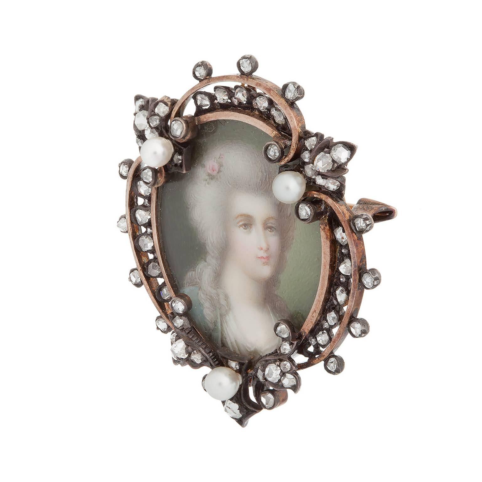 A gorgeous antique portrait brooch with diamonds and pearls.  There is an estimated 1.10cts total around the frame, with three small pearls, all in 18K yellow gold.  The brooch has a pin back as well as a small bale.

Inscription: 