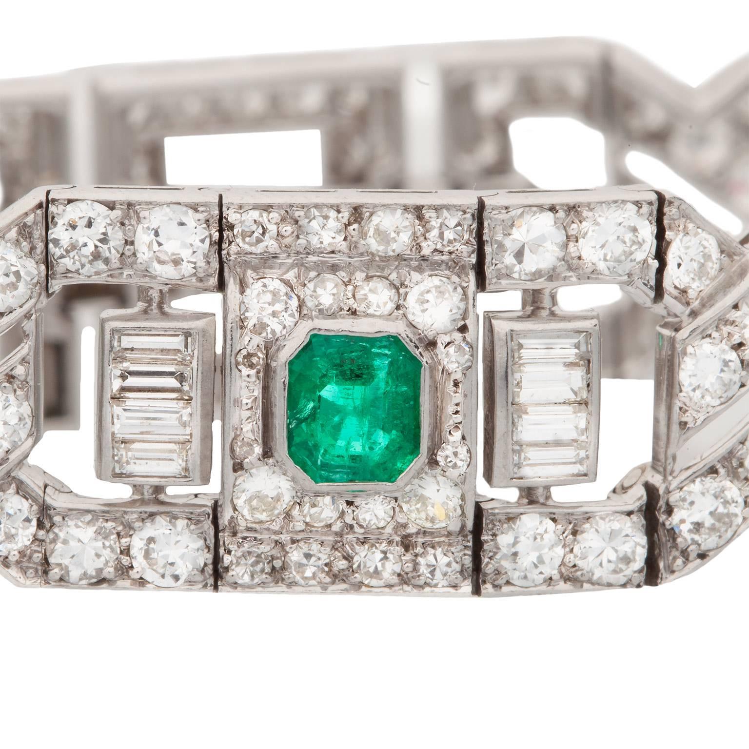 This is an absolutely stunning bracelet!  It is an Art Deco emerald and diamond link bracelet, made in platinum.  There are three emerald cut emeralds with a total estimated weight of 2.25cts, accompanied by a mix of round transitional cut, single