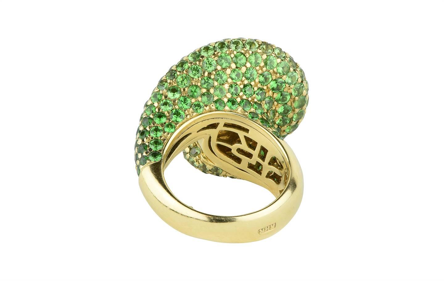 A stunning 12.20mm golden South Sea pearl and tsavorite garnet ring created by Rodney Rayner.  The ring is designed in the form of a curling wave containing an estimated 3.50cts in tsavorite garnets.

Signed:  Rayner
Hallmark:  750
*Currently a