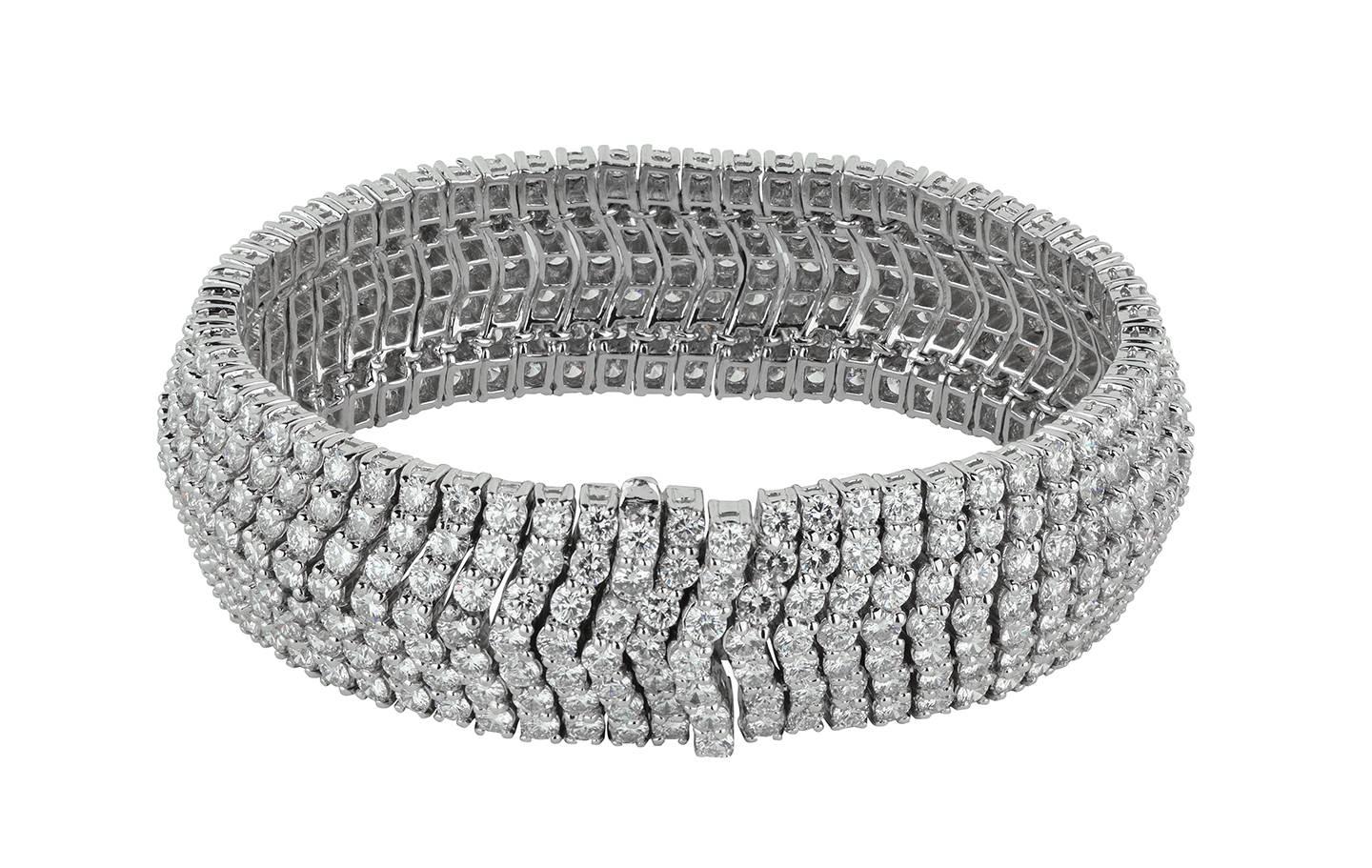 An absolutely stunning round brilliant diamond and platinum flexible bracelet.  There are seven rows of diamonds in a chevron shape pattern, totaling an estimated 30.64cts, F-G color, VS clarity.

Hallmark:  PT950
* 7.00 inches in length