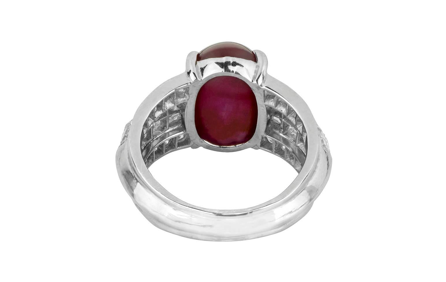 A magnificent Burma no heat cabochon star ruby and diamond  platinum ring by Cartier.  The 10.86ct ruby is prong set with two rows of ascher cut diamonds and two rows of round diamonds on both sides, combining for a total weight of 2.40cts.  The