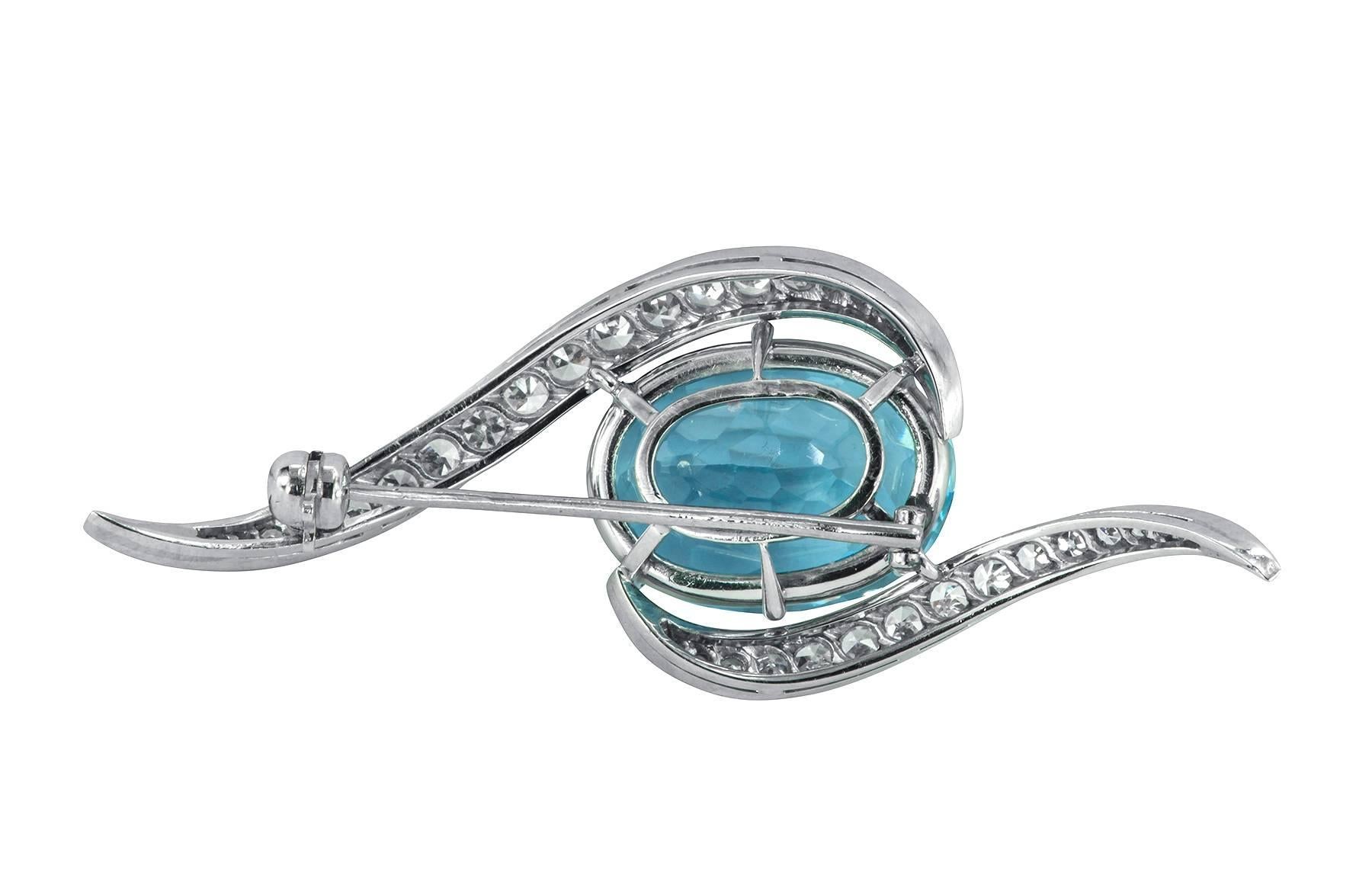 A gorgeous and easy to wear aquamarine and diamond platinum brooch.  The oval aquamarine is estimated to be 9.66cts, accompanied by 0.60cts in single cut diamonds in a curved bypass fashion.

2.12" in length