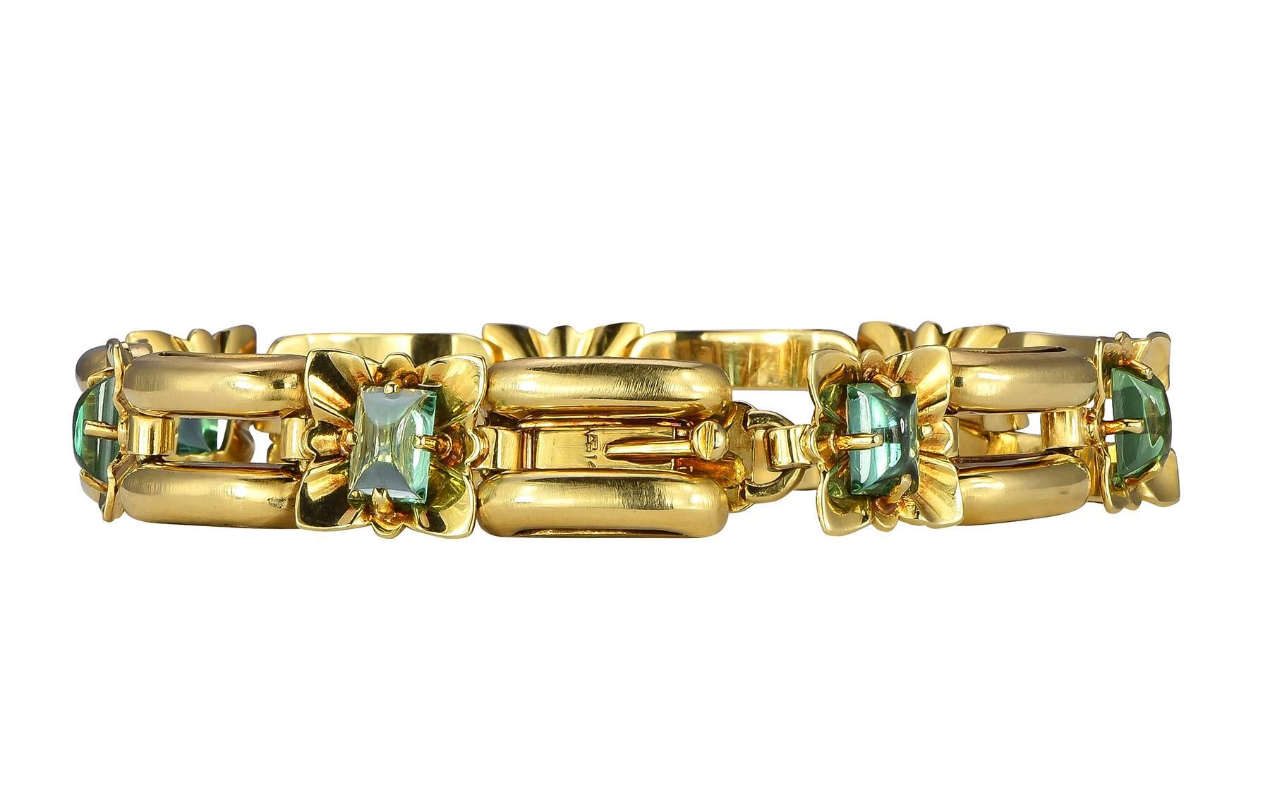 5.53ct cabochon green tourmaline and 14k yellow gold bracelet.  The tourmaline are prong set in a floral designed link, rotating every other woith double bar links.

Hallmark:  14K