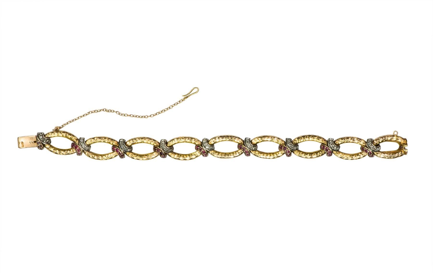 18k rose tone gold textured links, with 1.08cts in rose cut diamonds and 1.50cts in rose cut rubies, designed as bypasses between each link.  The bracelet was made circa 1880.

Hallmark:  (French)
Length:  6.75 inches