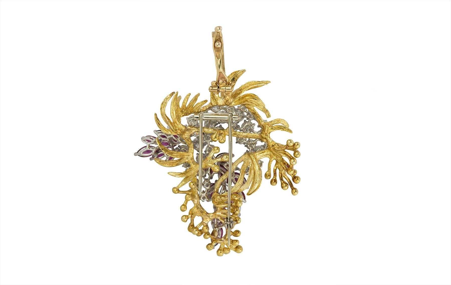 Diamond and ruby platinum and 18k yellow gold pendant and brooch.  The pendant contains 36 round brilliant diamonds of F-G color, VS clarity, weighing 4.55cts, and 19  marquise shaped rubies weighing 5.51cts total.  All of the stones are set in