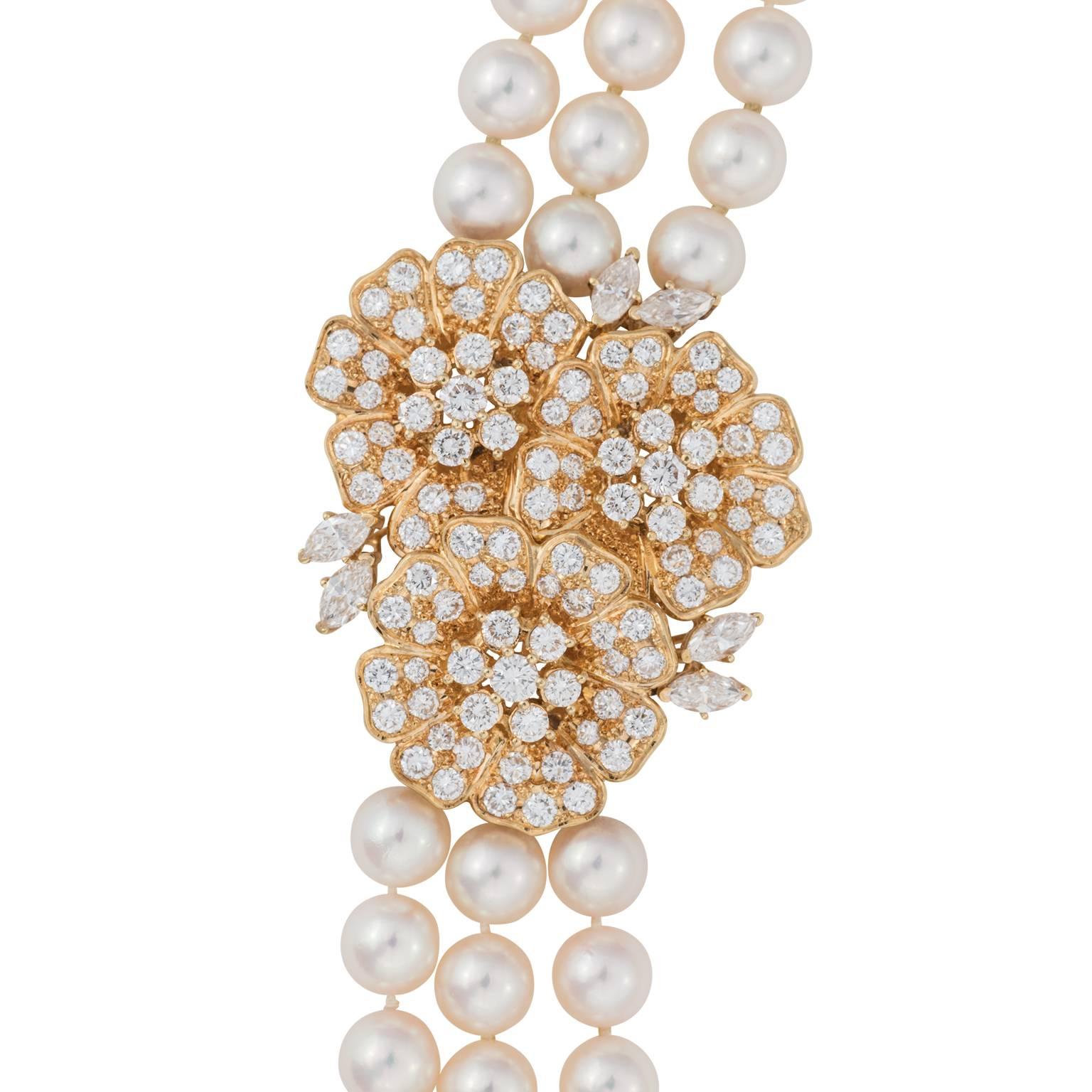 Mikimoto three strand nesting pearls with a diamond and 18k yellow gold clasp.  There are 285 cultured pearls, measuring 7.00-7.50 millimeters.  The clasp is made up of three connecting flowers, containing a mix of round brilliant and marquise