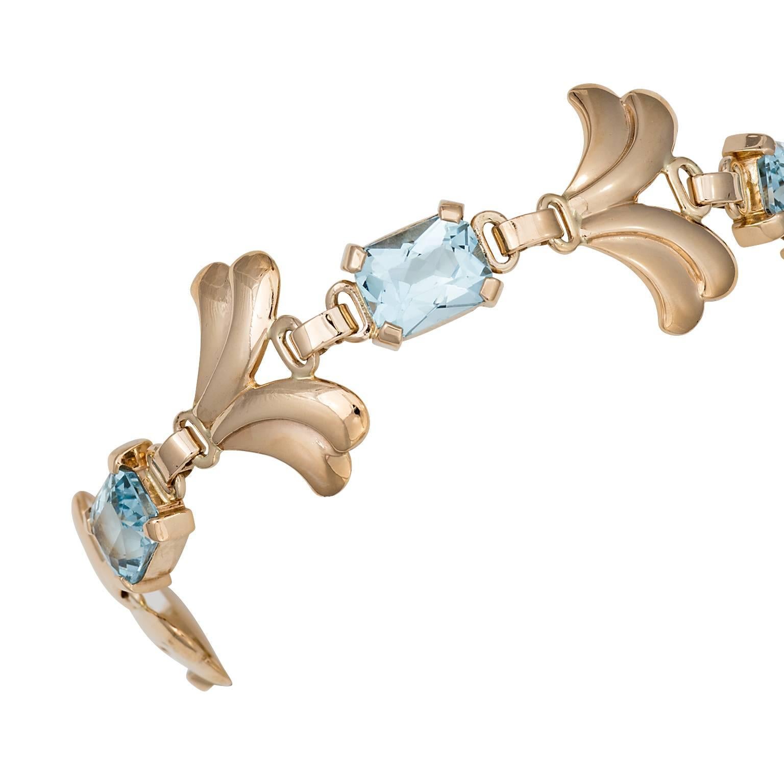 Tiffany & Co. retro style aquamarine bracelet in 14k rose gold.  The bracelet has four rectangular aquamarines weighing 7.20cts total, prong set between wing shaped links.

Length:  7.35 inches
Signed:  Tiffany & Co
Hallmark:  14K 