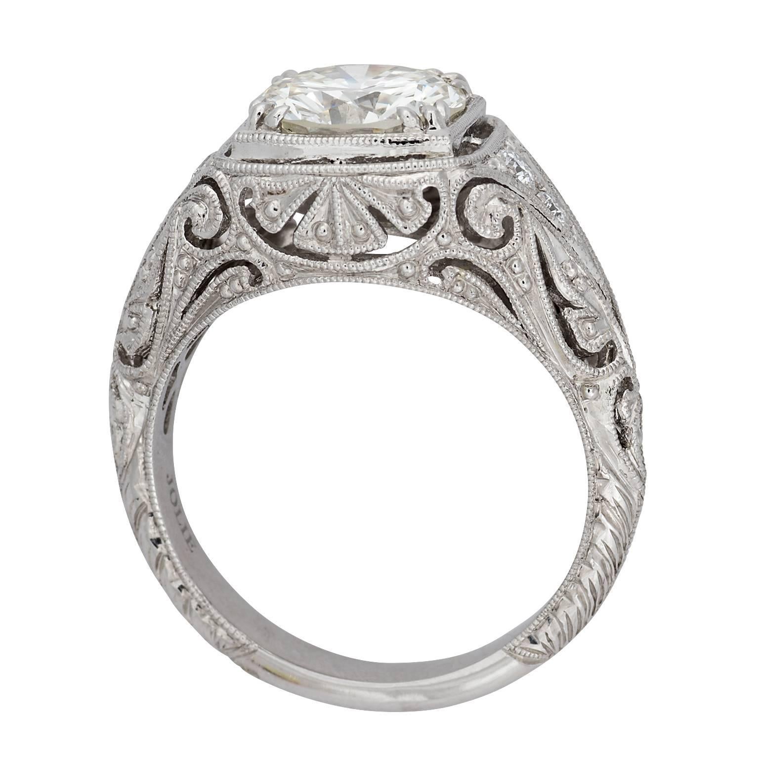 Art Deco style 1.99 carat round transitional cut diamond platinum engagement ring.  The diamond is graded by GIA as L color, VS2 clarity, set in a diamond filigree mounting.  There are four diamonds in the mounting, with a weight of 0.09 carats