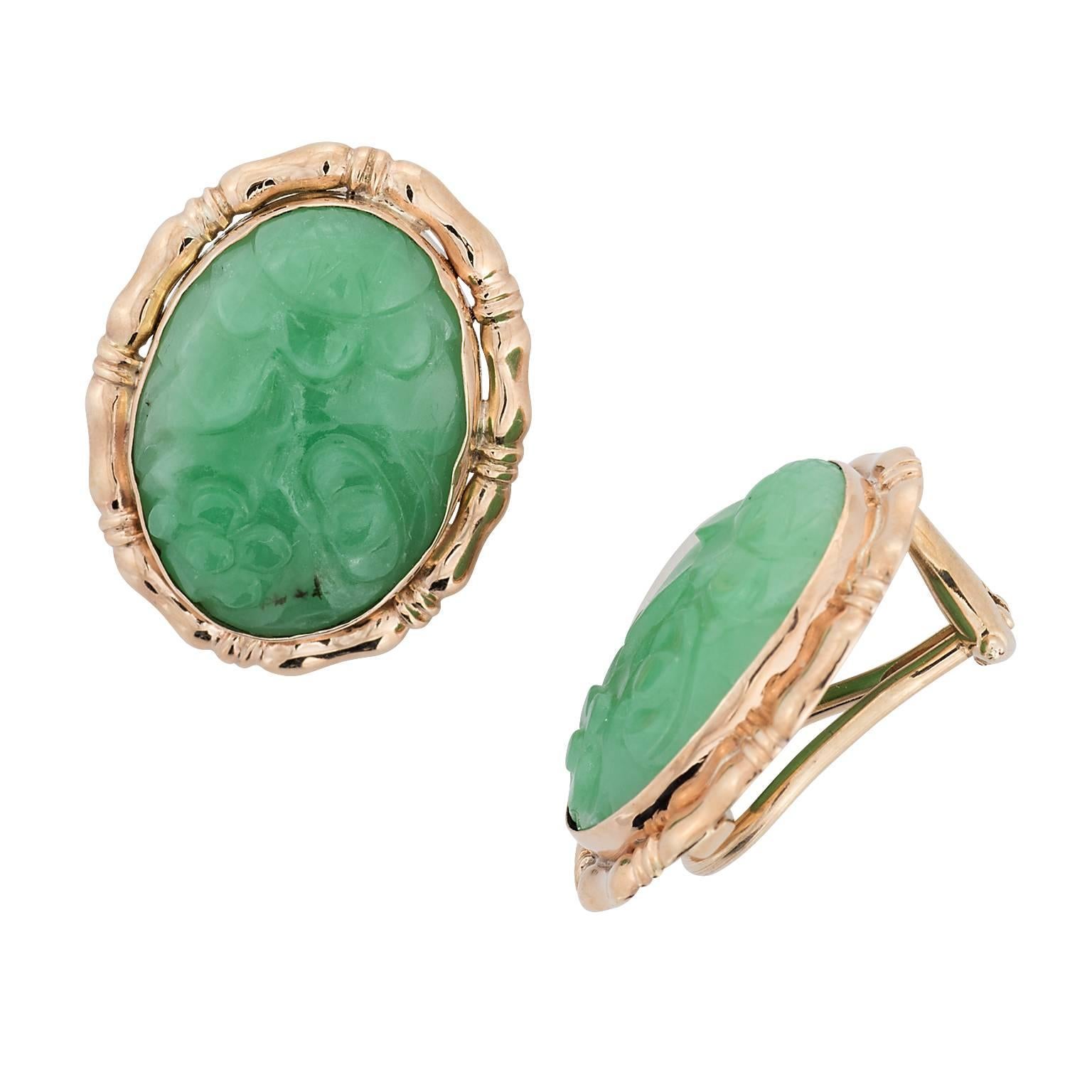 Craved Jade and 14k yellow gold earrings.  The jade depicts a floral scenery, bezel set with a textured frame, and a clip on back.  The jade measures approximately 18.30 x 13.60 millimeters.

Hall mark:  14K
**Post can be added 