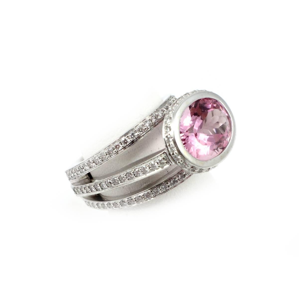 This custom ring by Scott Gauthier is crafted in 14k white gold. At its center is a bezel-set, 5.40ct pink tourmaline stone. The ring features three shanks that are set with round, brilliant-cut diamonds. The diamonds have a total weight of 1.00ct