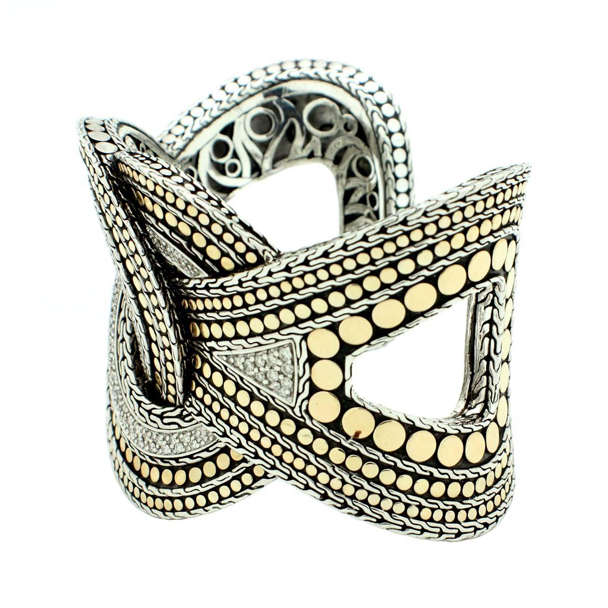 This woven dot cuff bracelet is crafted in sterling silver with 18k yellow gold accents by designer John Hardy. It is designed with 90 round, brilliant cut diamonds weighing a total weight of 3.60cts. The diamonds are graded F-G in color and VS-SI