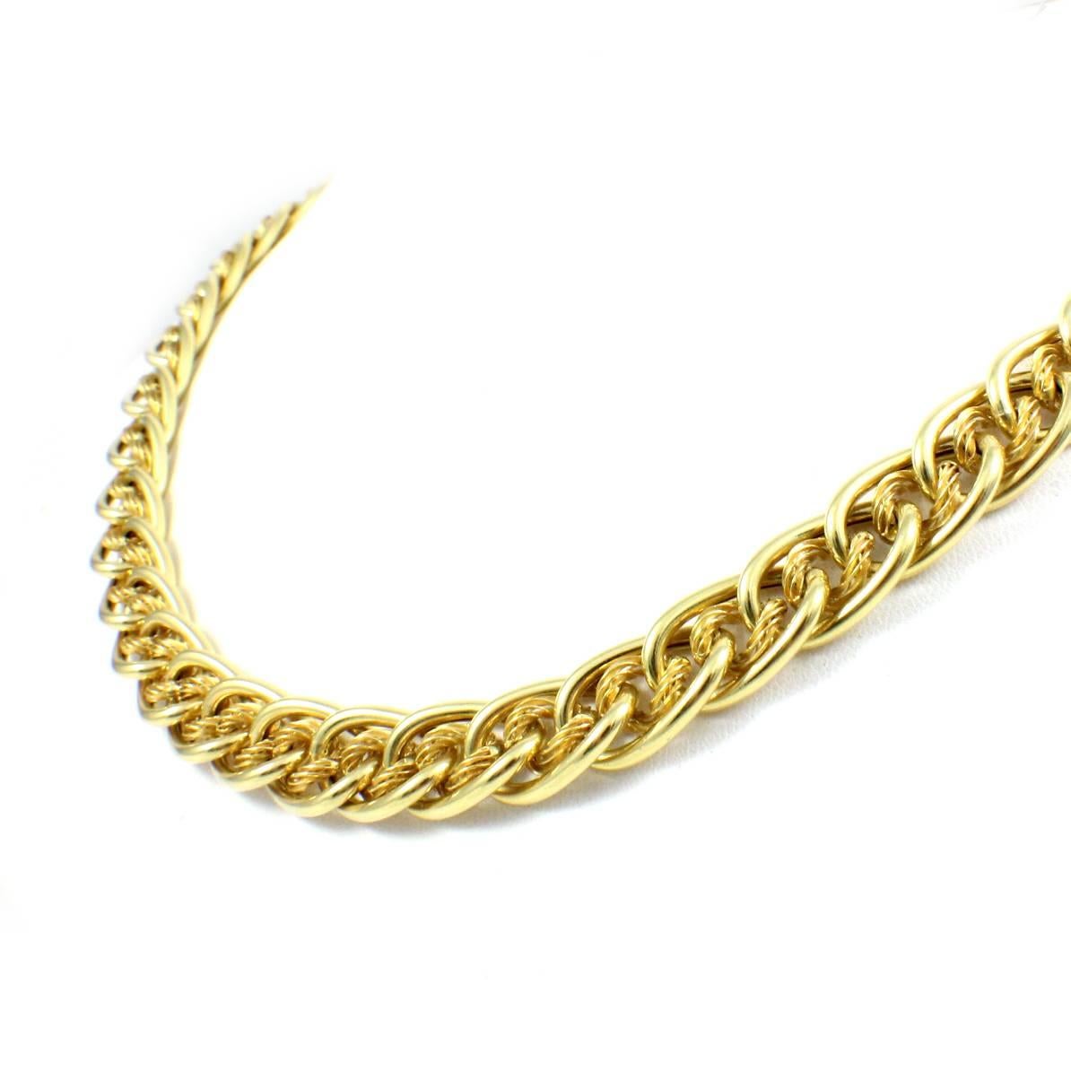 This necklace is made in 14k yellow gold. The necklace features multiple interlocking chains, stamped “Brev” on the clasp. The necklace itself measures 18 inches in length and 10mm in width. It weighs 50.1 grams.  