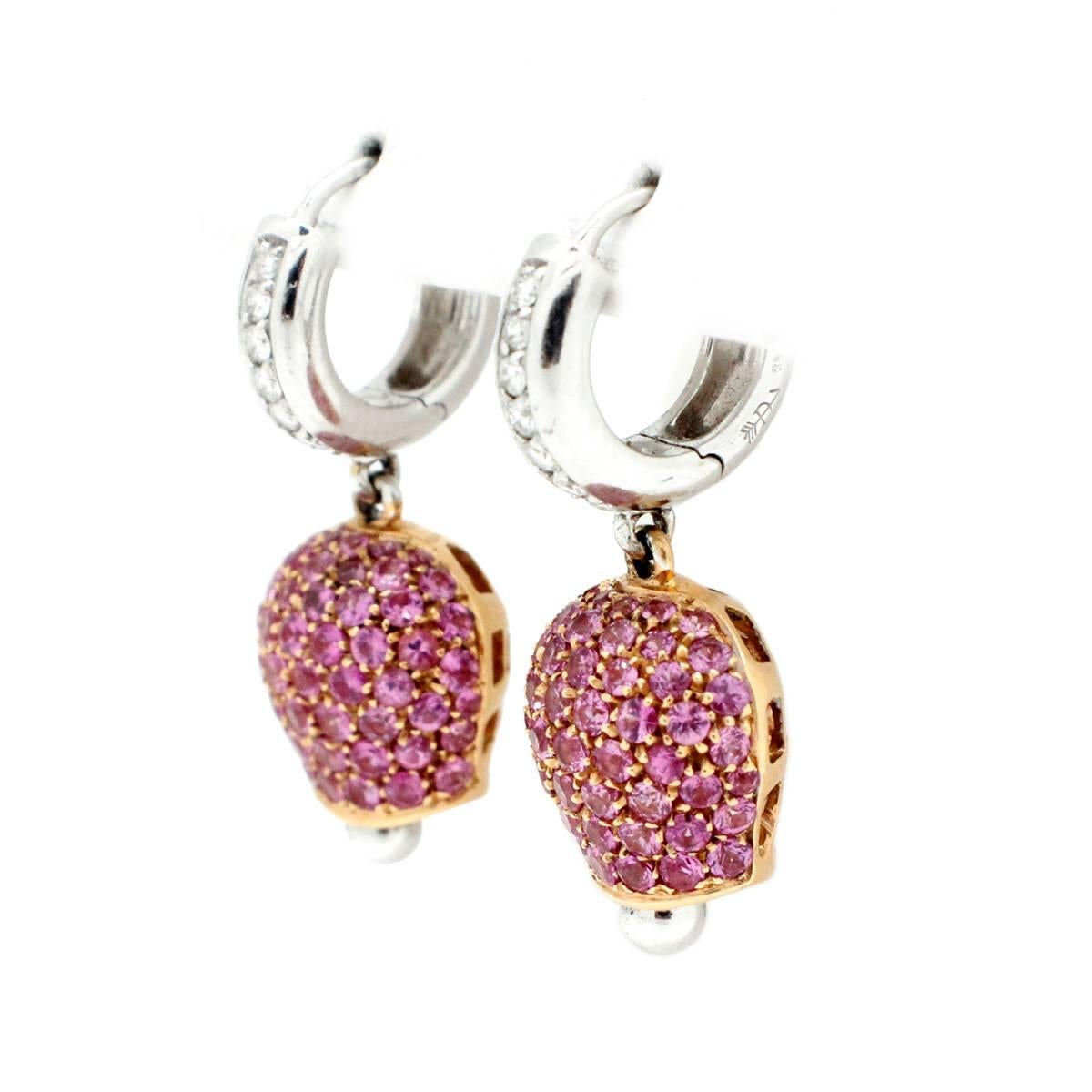These earrings are made in both 14k white gold and 14k yellow gold. The earrings feature white gold huggies set with round diamonds. The diamonds have a total weight of 0.28 carat. Then there are yellow gold dangling attachments that are set with