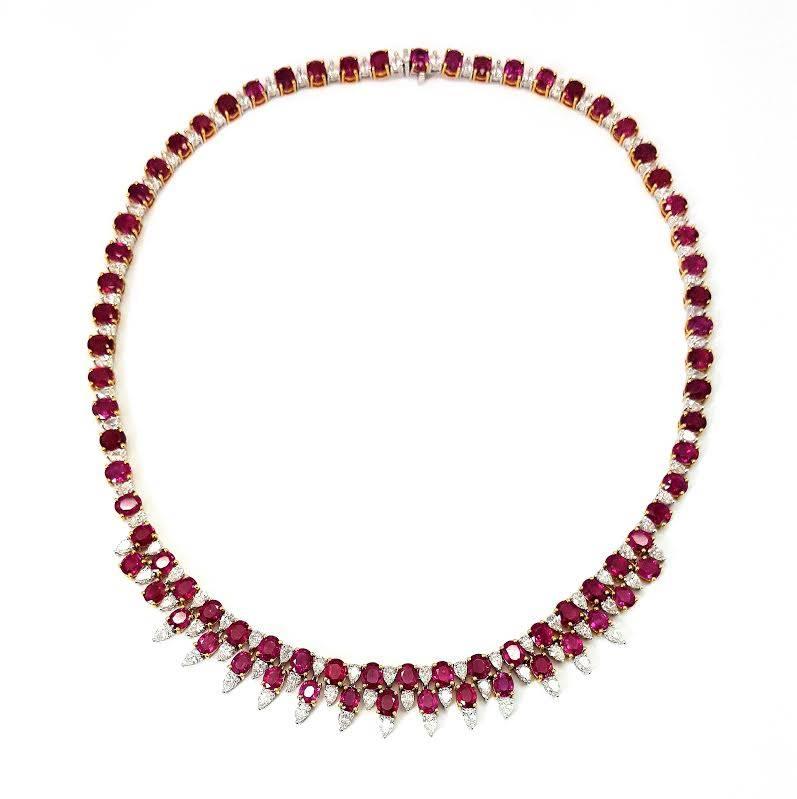 Simply Stunning! This one-of-a-kind diamond and ruby necklace is set in 18k white gold. There are 90 diamonds that are accenting the rubies. The 90 diamonds have a total carat weight of 11.19 carats. The diamonds are G in color and VS in clarity.