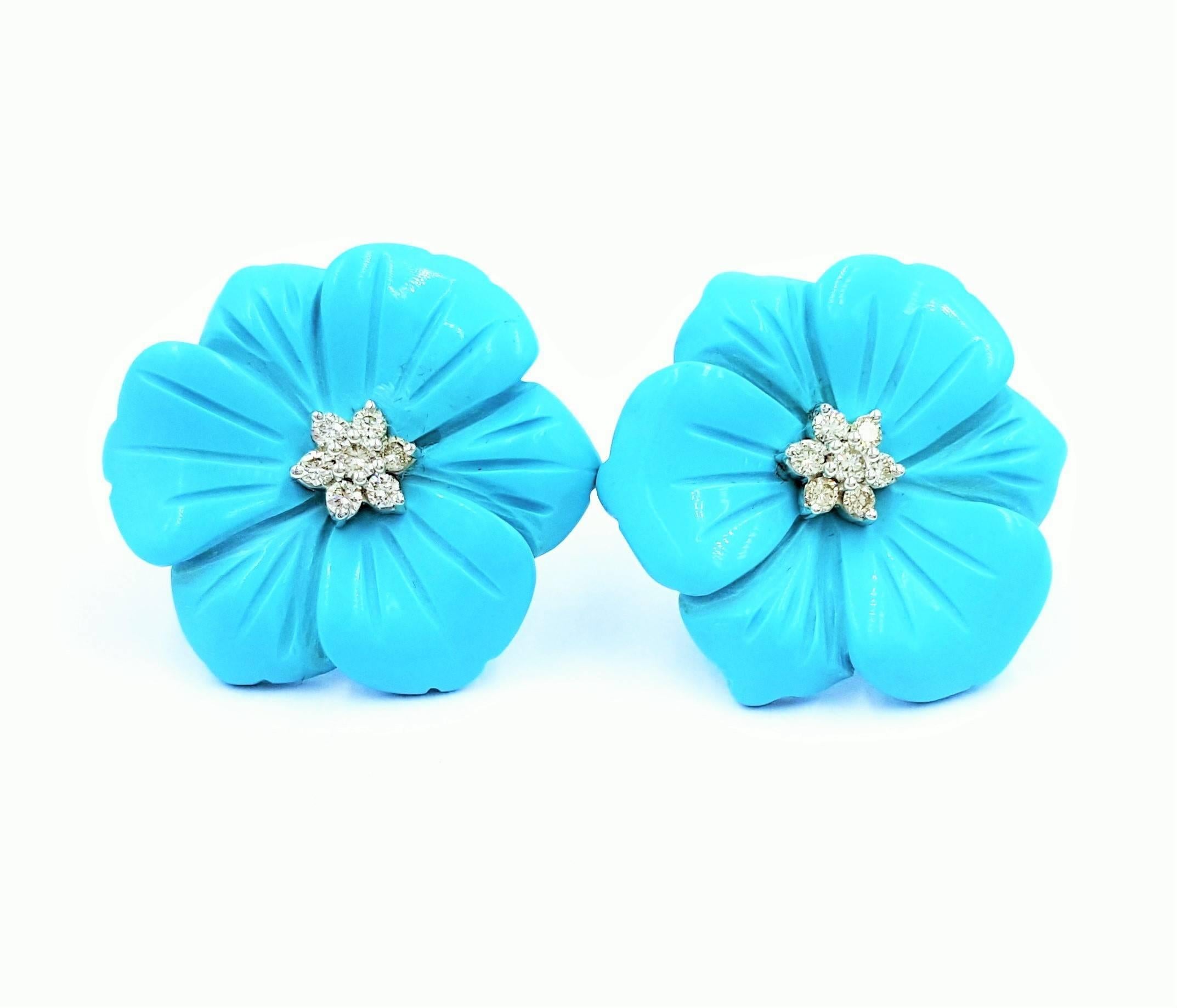 These gorgeous hand carved Persian Turquoise flower motif earrings feature .25 carats of ideal cut round brilliant diamonds in the center set in 14kt white gold bringing life and fire out of these captivating stud style earrings. An exclusive brand