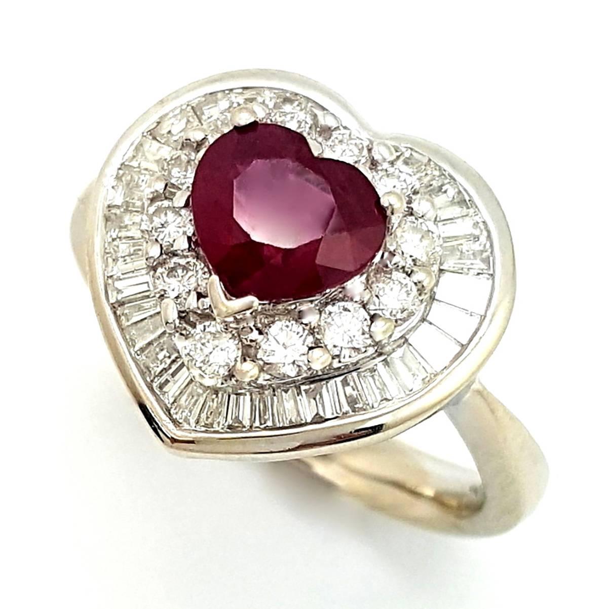 This 18k white gold diamond and ruby ring is simply amazing! The ring features a beautiful truly red 0.92ct heart cut ruby gemstone adorned with 1.32cts of diamonds. There are 12 round brilliant cut diamonds prong set in the first halo equaling